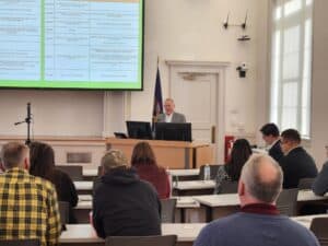 Agricultural conference with a speaker presenting to vegetable growers at NYSVGA event.